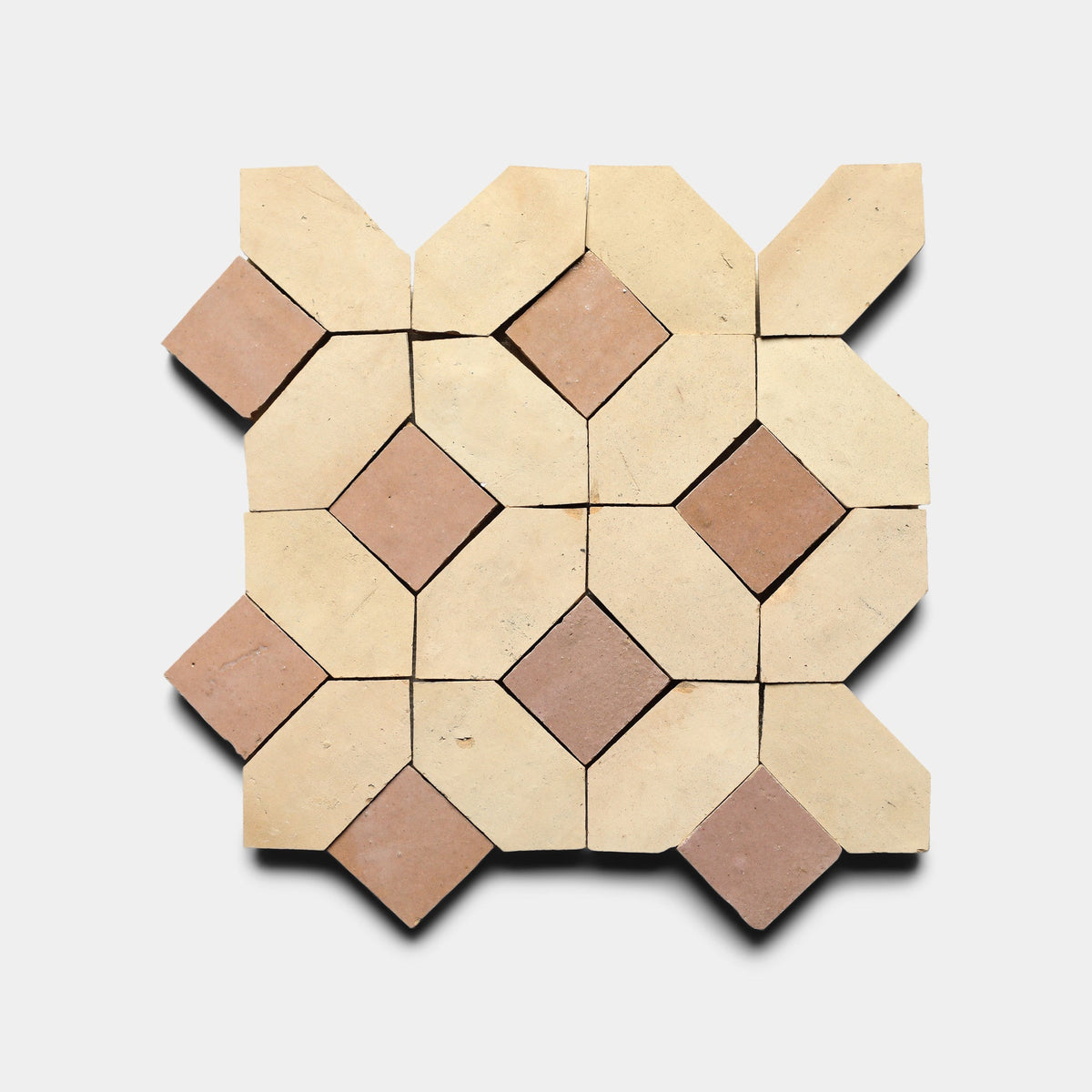 The Lattice 2 Sample by Zia Tile features a geometric pattern of beige and brown trapezoids and diamonds in an interlocking design on white, inspired by classic Zia Tile cement craftsmanship.