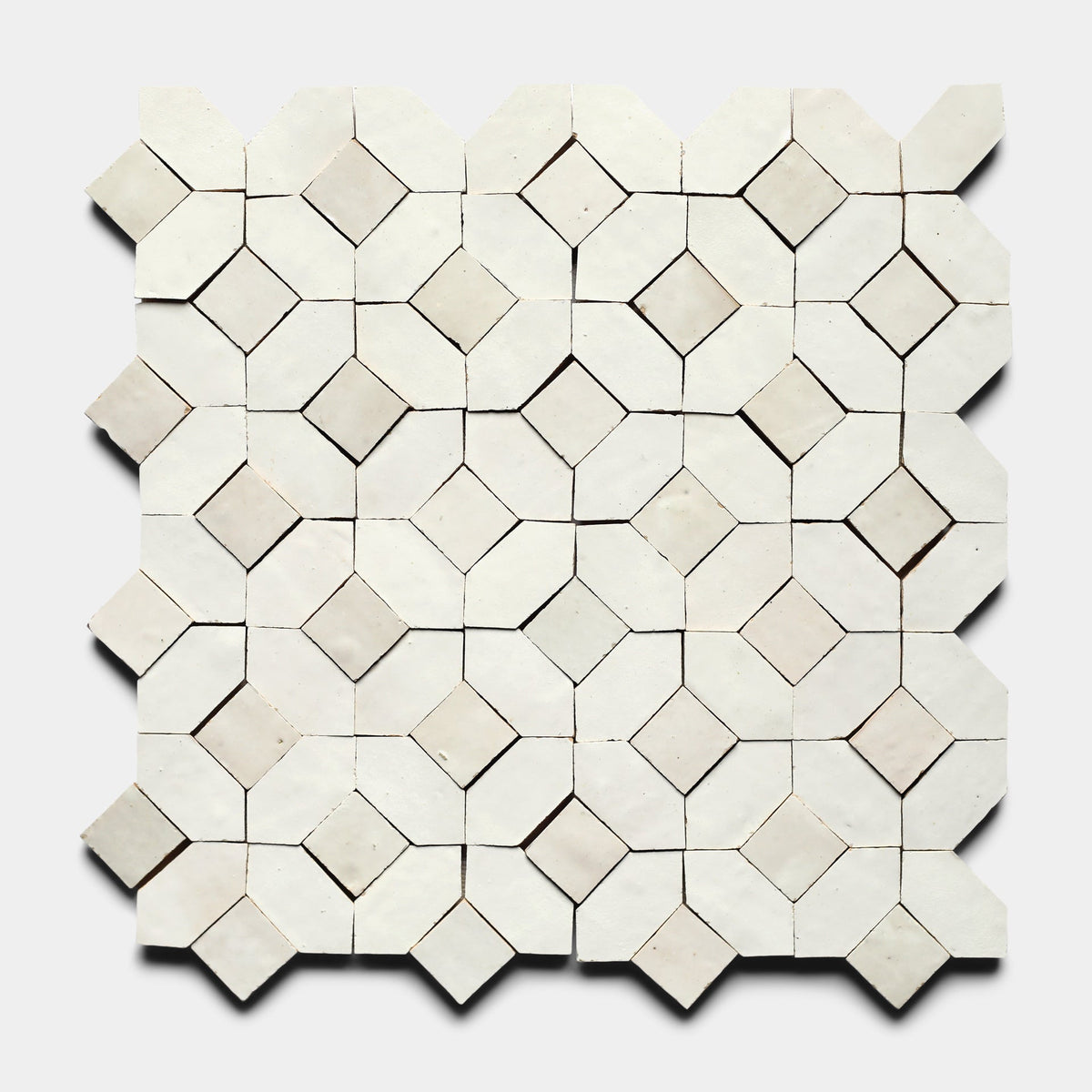 The Lattice 4 sample from Zia Tile features a handmade square tile mosaic with an alternating diamond and square geometric pattern in white and cream tones on a light gray background.
