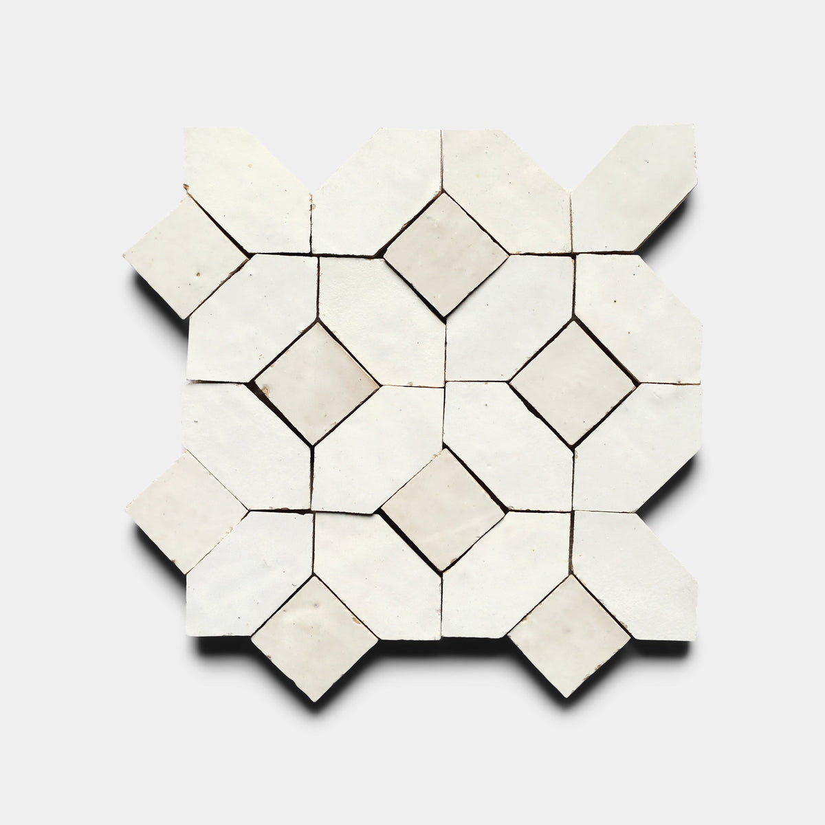 Lattice 4, Sample by Zia Tile features a geometric pattern of diamond and hexagon shapes in white on a light background—ideal for adding timeless, handmade elegance to any space.