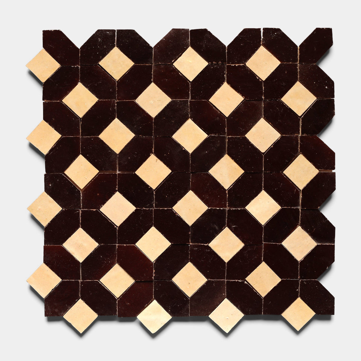 Lattice 6 by Zia Tile features a geometric tile pattern with alternating dark brown octagons and small cream diamond shapes, forming a repeating grid on a light background.