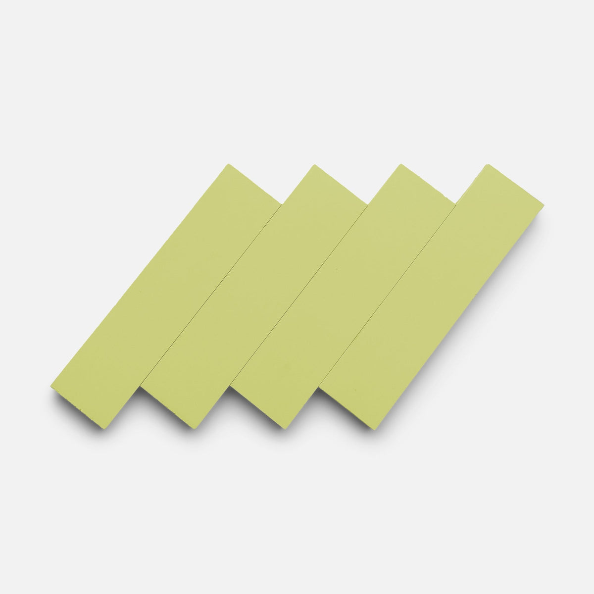 Four Lemongrass 2x8 tiles by Zia Tile, in light green, are arranged diagonally and overlapping on a plain white background.