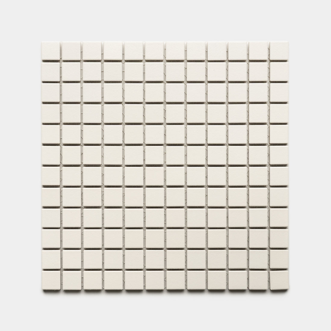 Linen 1x1 by Zia Tile features small, square, off-white tiles arranged in an even grid of rows and columns on a white background.