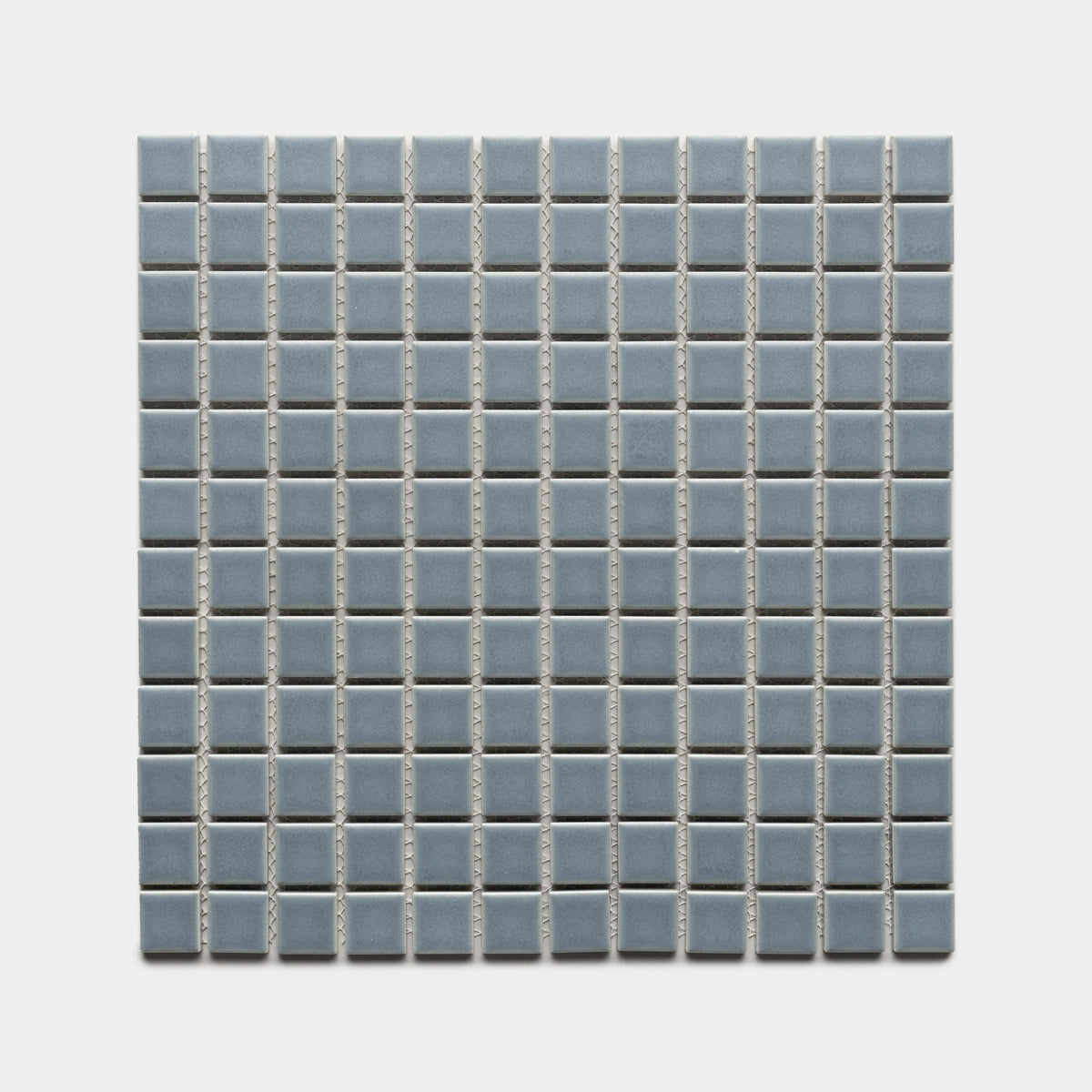 Loch 1x1 by Zia Tile features small, light blue ceramic tiles in a square grid with white grout lines, evenly arranged on a light background.