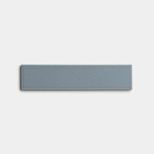 The Loch 2x8 by Zia Tile is a single rectangular blue-gray tile with a smooth matte finish, shown against a plain white background.