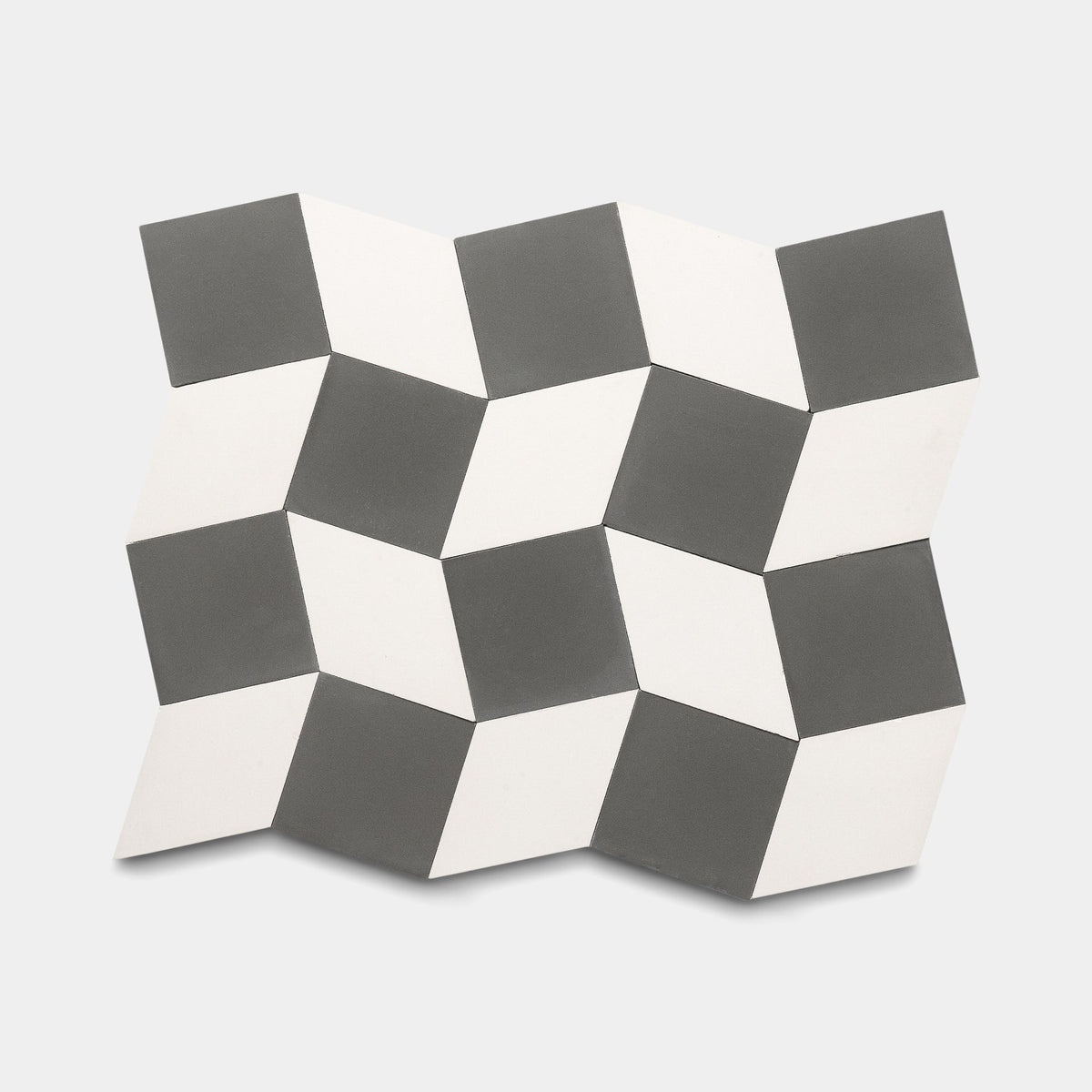 The Madrid Ash + White sample by Zia Tile features a geometric cement tile pattern of black, white, and gray cubes, creating a striking 3D optical illusion on a light background.