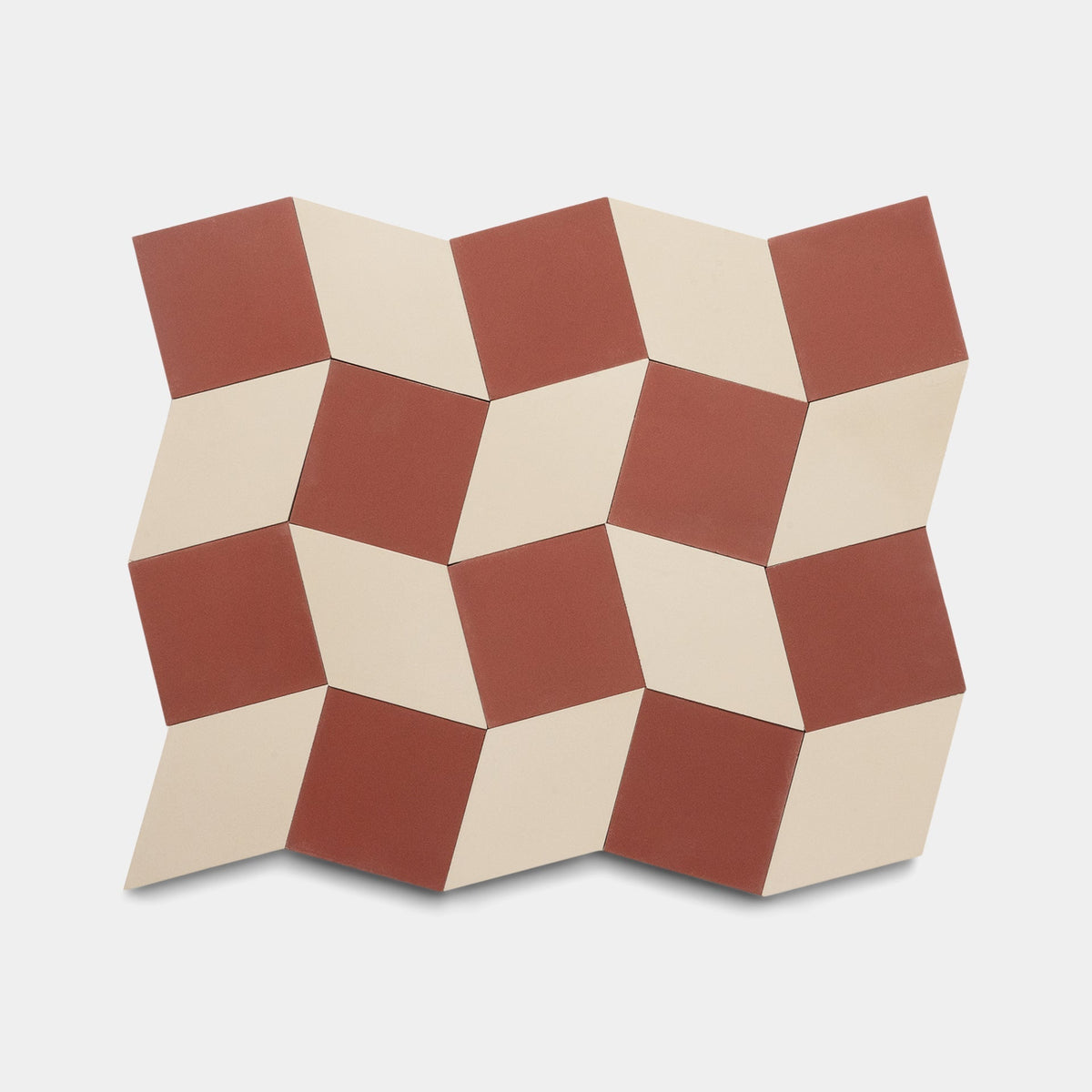 The Madrid Canyon + Bone sample by Zia Tile features a geometric cement tile pattern with red and cream diamond shapes, creating a striking three-dimensional effect ideal for elevating any space.