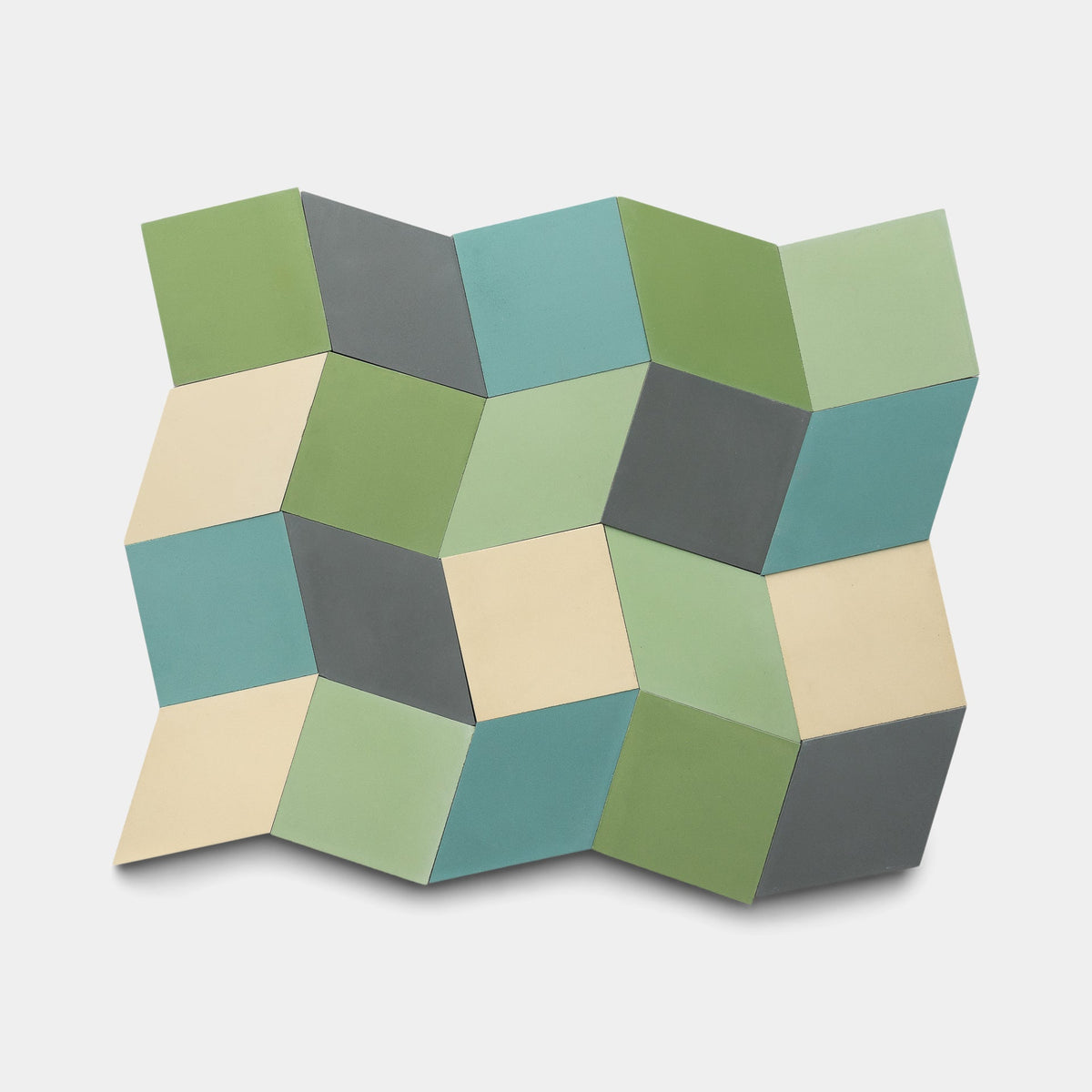 The Zia Tile Madrid Set Four, Sample features a geometric pattern of interlocking 3D cubes in green, blue, gray, and beige on white, creating an eye-catching optical illusion of depth and dimension.