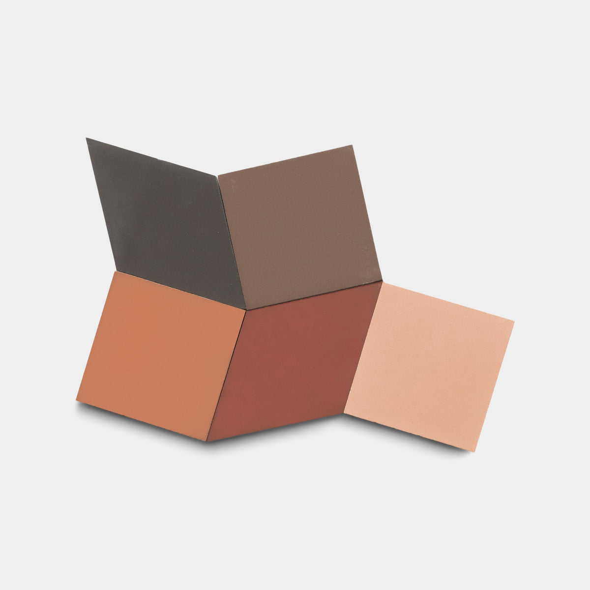 Four Zia Tile Madrid Set One samples in black, brown, terracotta, and light pink are arranged in a connected fan pattern on a plain white background.