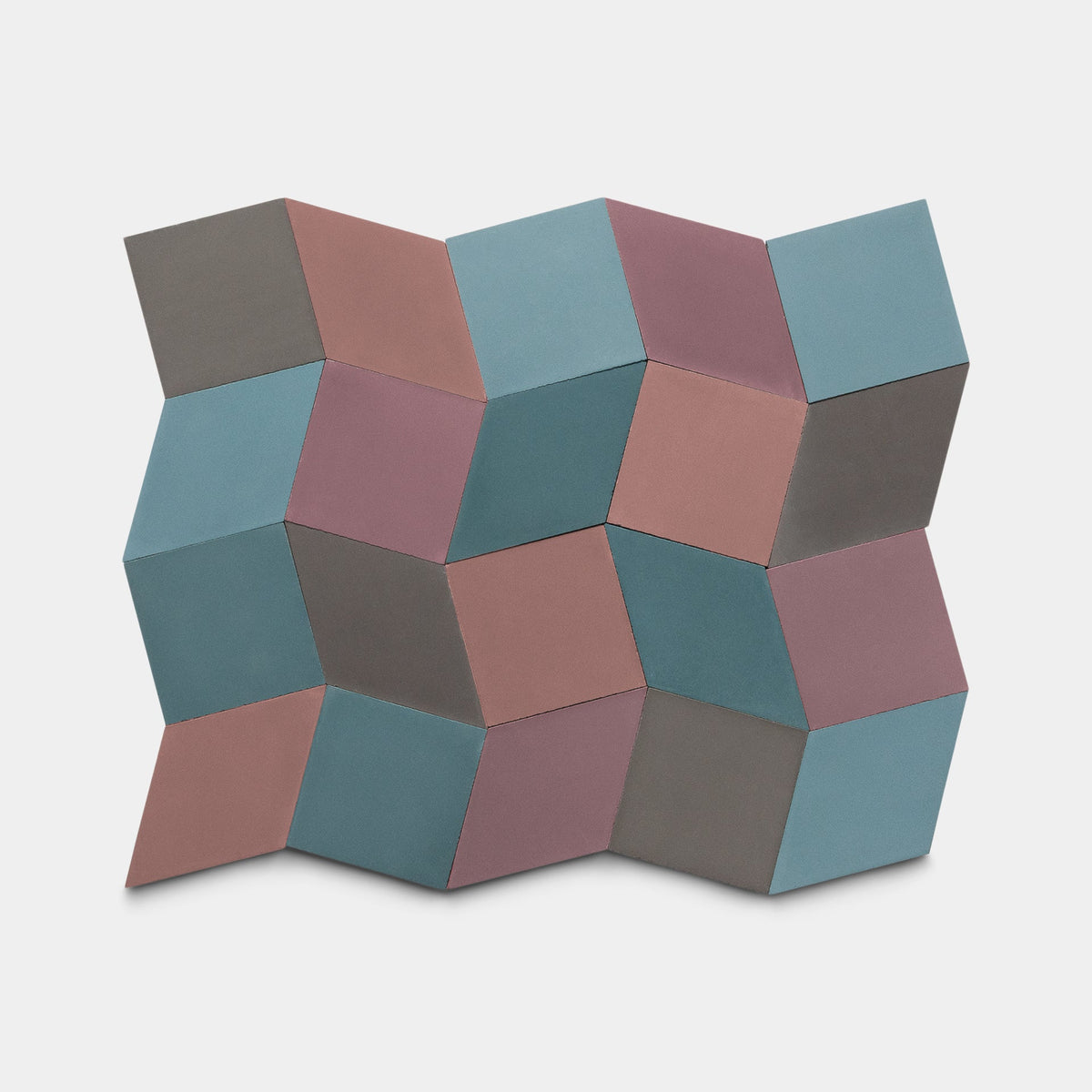 The Madrid Set Three sample by Zia Tile features geometric cement tiles in interlocking blue, mauve, and gray cubes, creating a bold three-dimensional optical illusion.