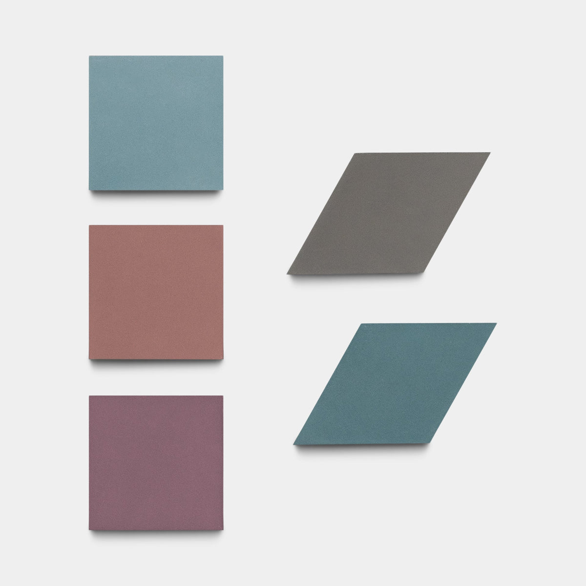 Six colored tiles are arranged on a white background: three Zia Tile Madrid Set Three squares in teal, terracotta, and mauve at left; at right, three parallelogram handmade cement tiles in dark gray, blue, and teal.