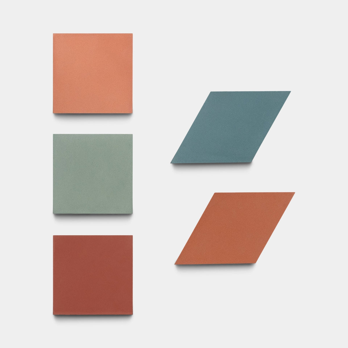 Six tiles on a white background: three squares in orange, green, and red on the left, and three blue and orange parallelogram-shaped Madrid Set Two samples by Zia Tile on the right.