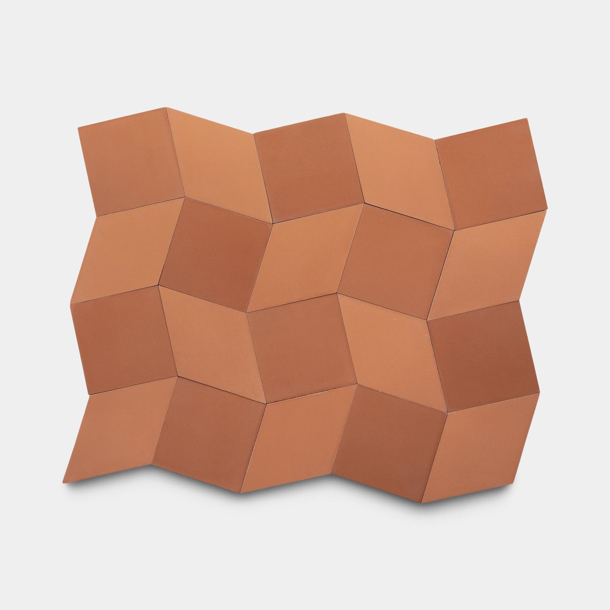 Madrid Terra Cotta + Rust by Zia Tile features handmade cement tiles in a geometric cube pattern on a light background, creating an optical illusion of depth and texture. Sample available.