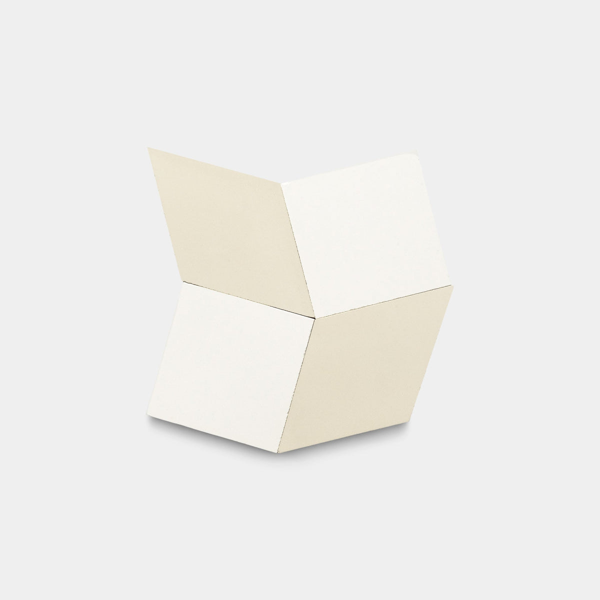 The Madrid White + Bone, Sample by Zia Tile features four connected cream panels in a minimalist geometric sculpture, evoking handmade tile with clean lines and angular form against a light gray background.