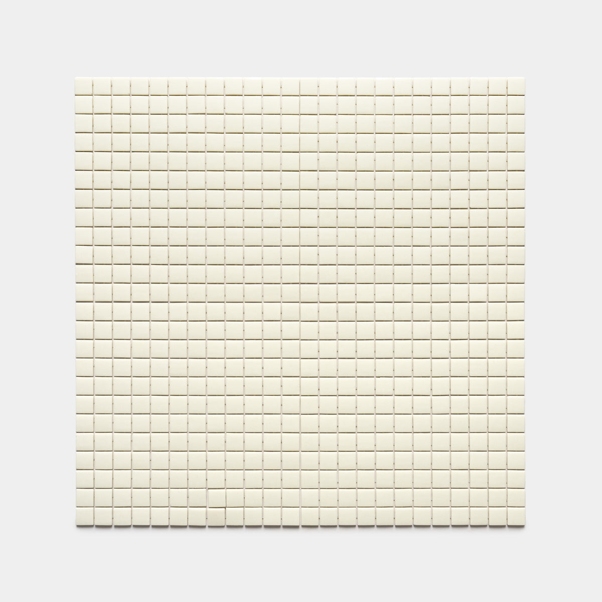The Milk 1x1 tile by Zia Tile features a square grid of small, evenly spaced, off-white tiles arranged in neat rows and columns against a plain light gray background.