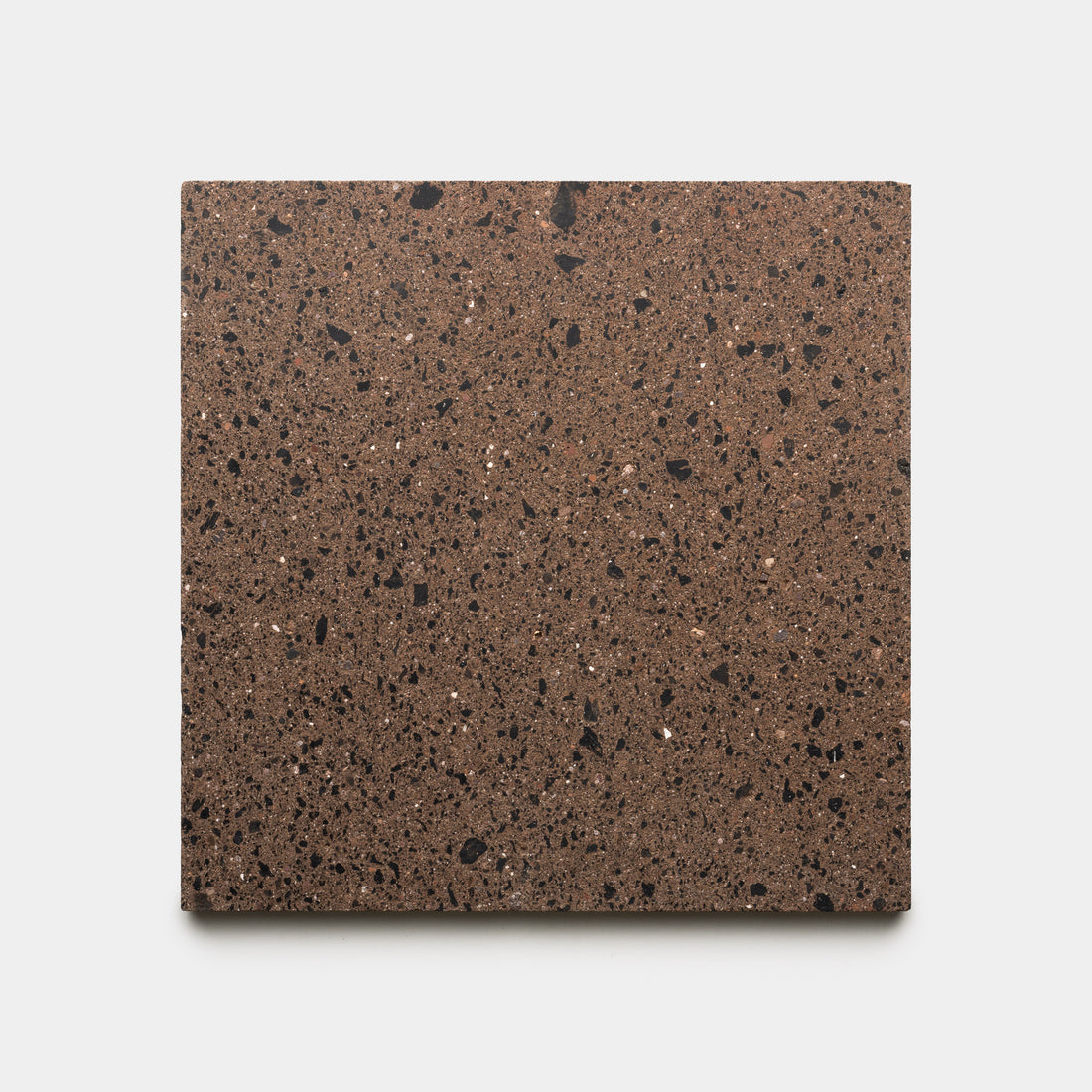 The Moab 12x12 tile by Zia Tile is a square brown stone tile featuring a speckled pattern of small black and white flecks, shown on a plain white background.