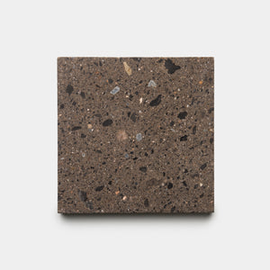 The Moab 6x6 Sample by Zia Tile is a rectangular dark brown terrazzo slab featuring black, gray, and light brown specks, shown against a plain white background.
