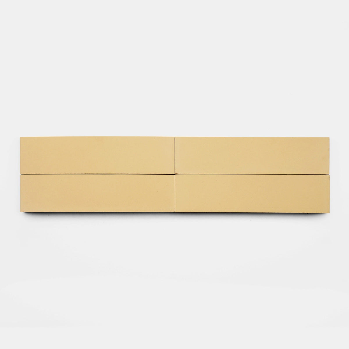 Four Mojave 2x8 samples by vendor-unknown, in beige, are arranged horizontally with even spacing for a symmetrical, minimalist look against a white background.