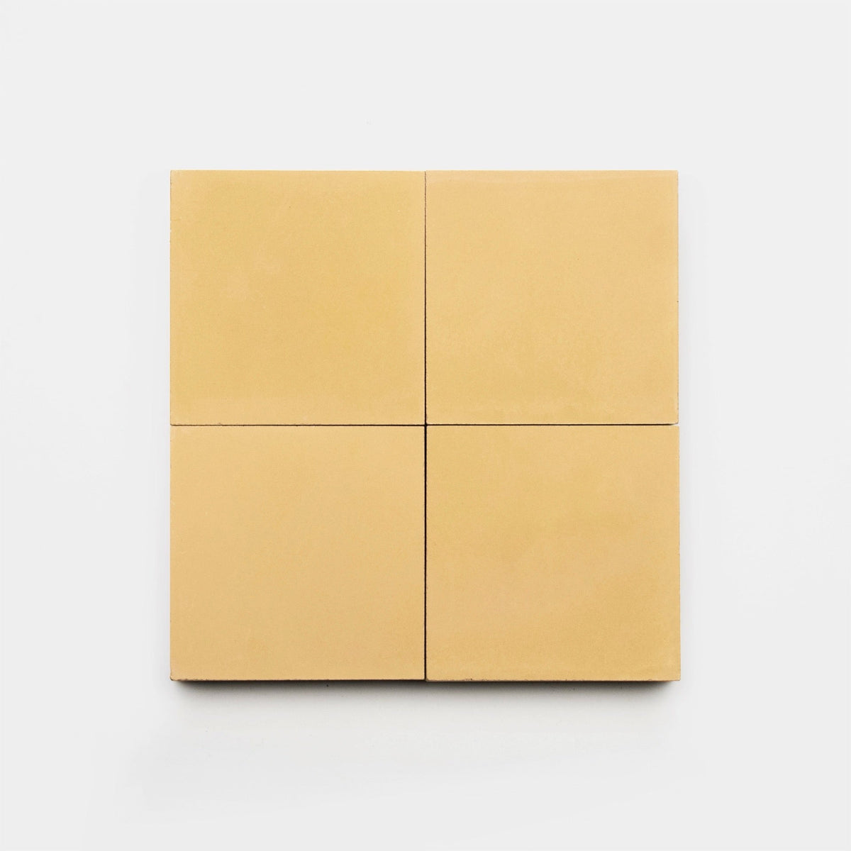 Four Mojave 4x4 sample tiles from vendor-unknown are arranged in a 2x2 grid against a white background. Each beige tile features smooth surfaces and sharp edges, giving them a clean, minimalist look.