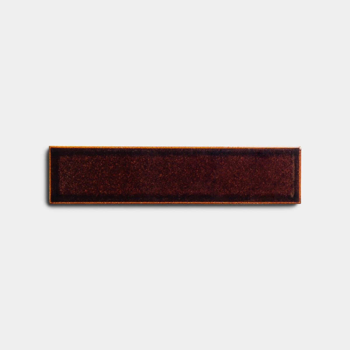 A 2x8 rectangular dark red and brown velvet Molasses sample patch with a black border from Zia Tile, displayed on a plain white background.