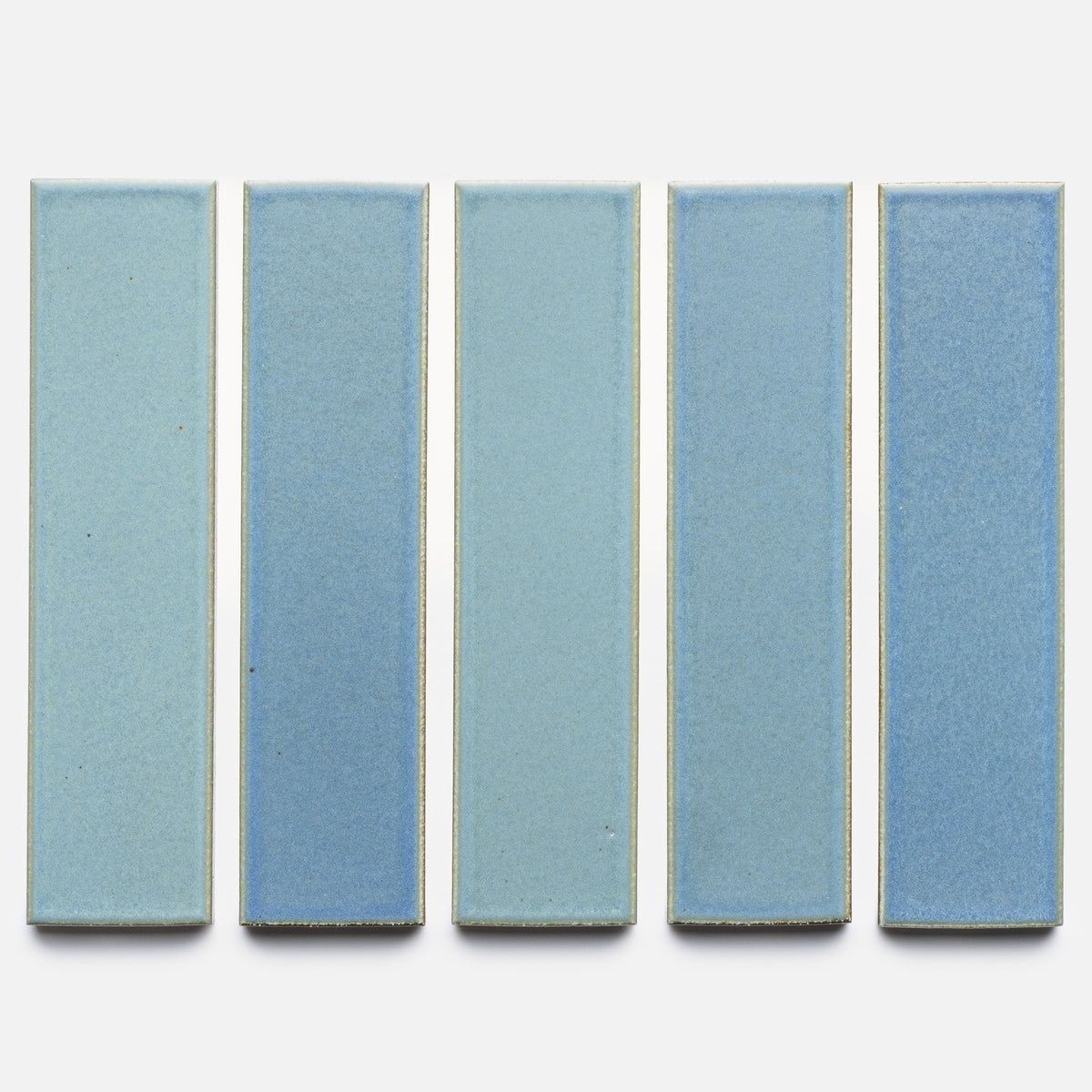 Five rectangular Morning Light + Flat, Sample tiles by Zia Tile, in light blue ceramic, are arranged vertically in a row against a white background with small gaps between each tile.