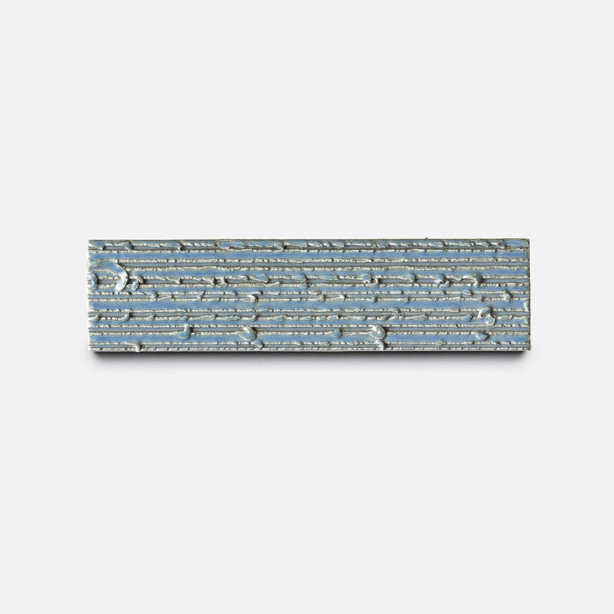 The Morning Light + Furrowed Sample by Zia Tile is a rectangular ceramic tile featuring a light blue and beige crackle pattern with stacked horizontal lines, shown against a plain white background.