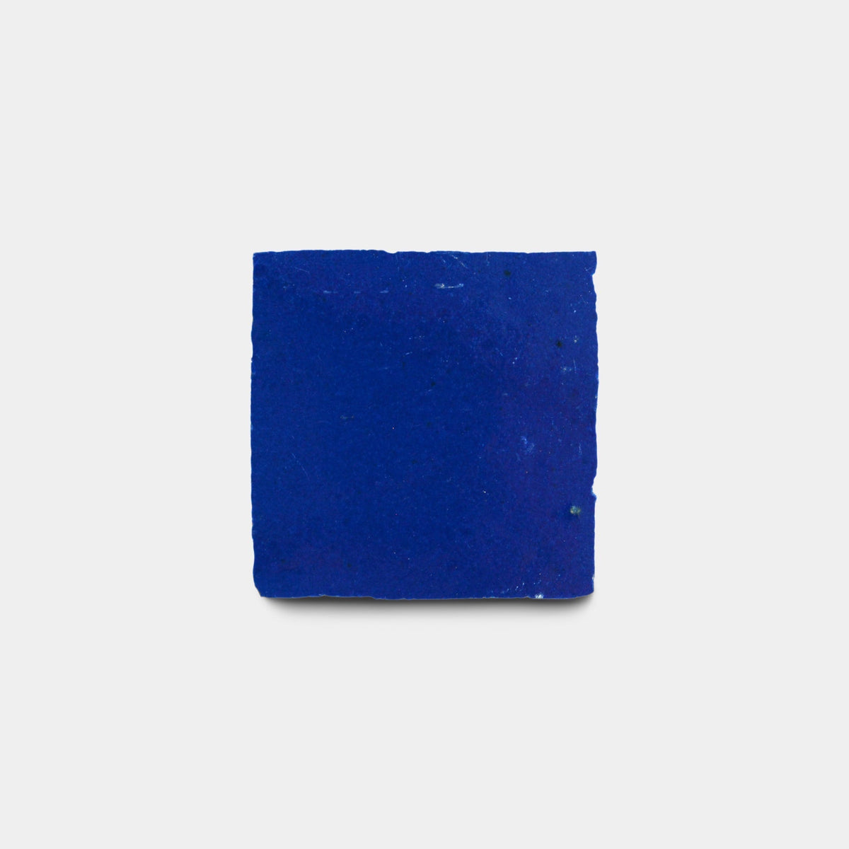 The Maya Blue 2x2 Sample by Zia Tile is a solid, vibrant cobalt blue tile, shown against a plain light gray background.