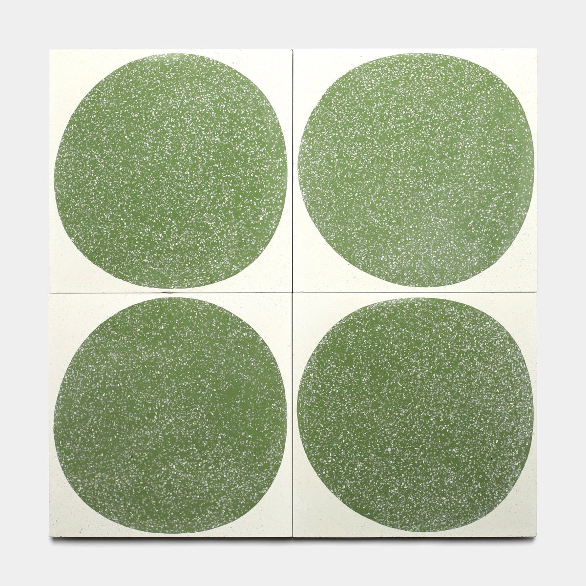Four Zia Tile Moxie Saguaro 12x12 sample tiles are arranged in a 2x2 grid, each displaying a bold, speckled green circle on white for a modern, unified geometric look.