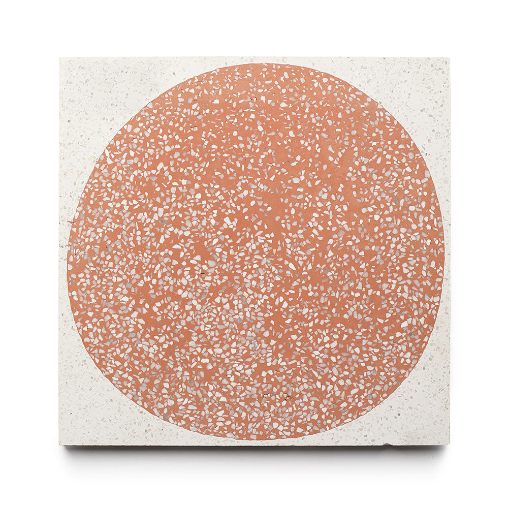 The Moxie Rust 12x12 Sample by Zia Tile is a square handmade cement tile with a large textured terracotta circle with white speckles on a smooth off-white background, offering a unique and modern design statement.