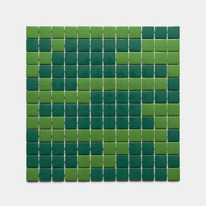 The Murano Clover + Jasper sample by Zia Tile features a rectangular grid of small square tiles in alternating light and dark green, creating a symmetrical geometric pattern on a white background.