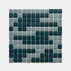 A square grid of Zia Tile's Murano Marine Layer + Vespertine Sample tiles forms a pixelated smiley face in dark teal and light gray on a white background.