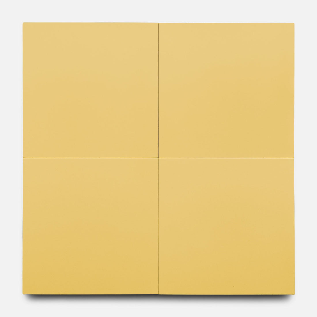 The Mustard 8x8 by Zia Tile features four equal square yellow panels in a grid, forming a larger square. Inspired by handmade tile design, subtle lines separate each panel, all set on a white background.