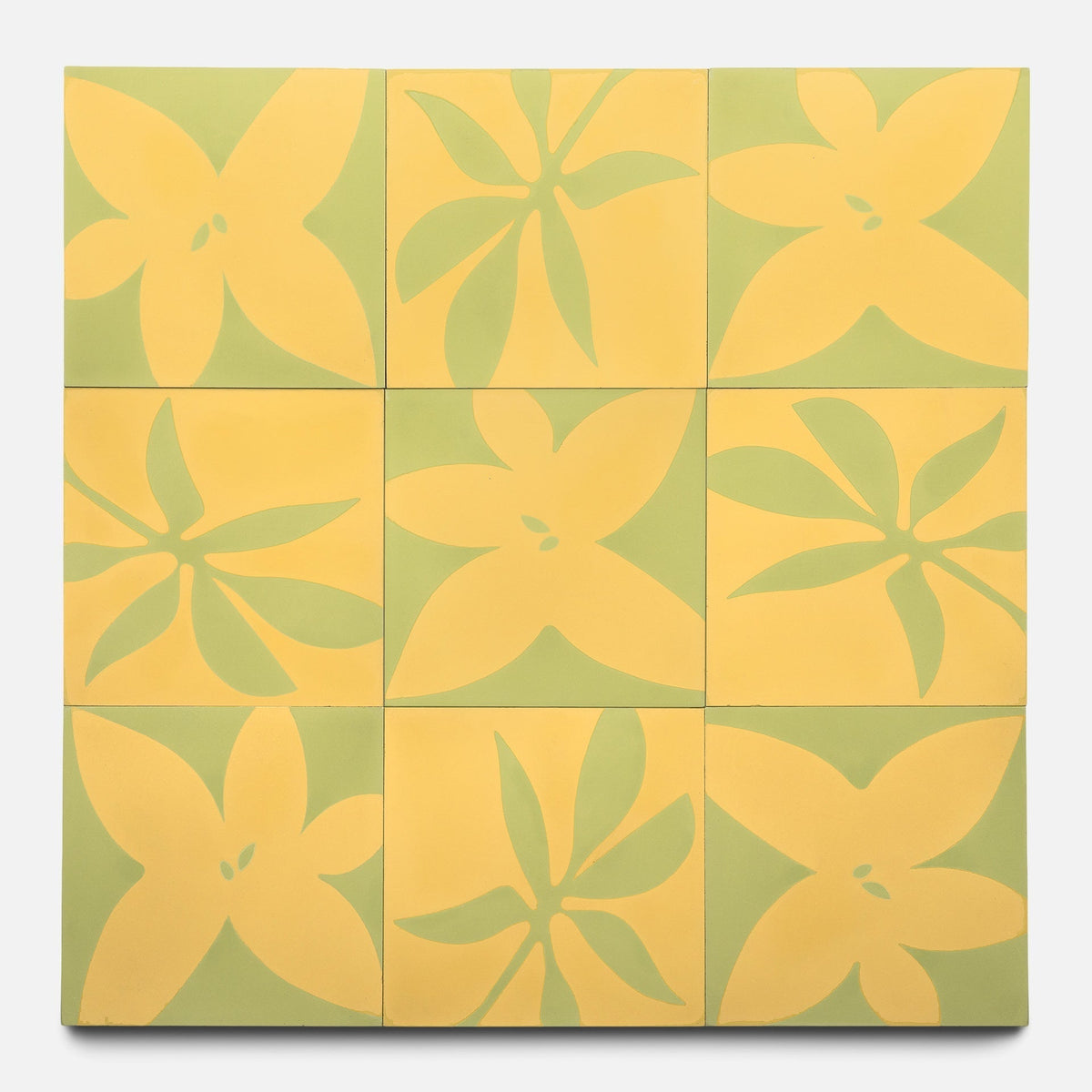 Nine Flora 8x8 Set Mustard + Lemongrass tiles by Zia Tile are arranged in a grid, each displaying a stylized five-petal yellow floral pattern on a green background that continues seamlessly across the set.