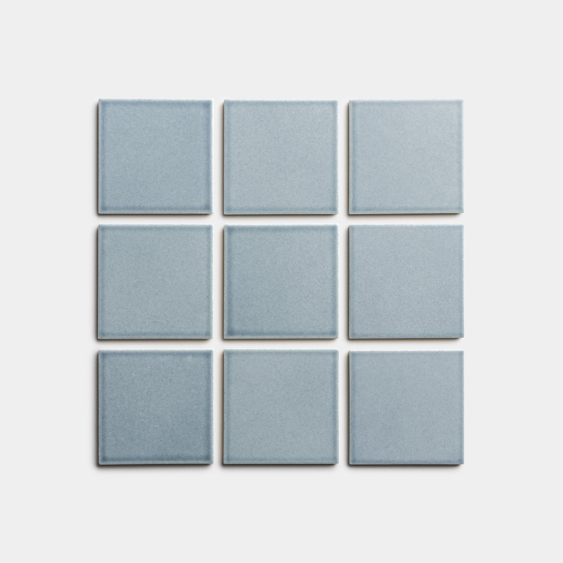 Nine Mystic 4x4 light blue square tiles by Zia Tile are arranged in a 3-by-3 grid on a plain white background.