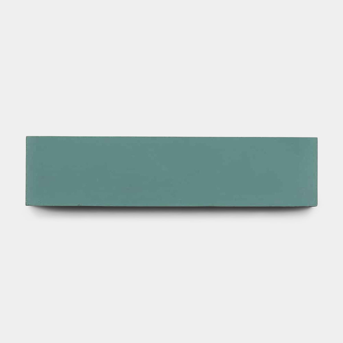 A rectangular, teal Neptune 2x8 sample by vendor-unknown is displayed against a plain white background, its color echoing stylish Zia Tile designs.