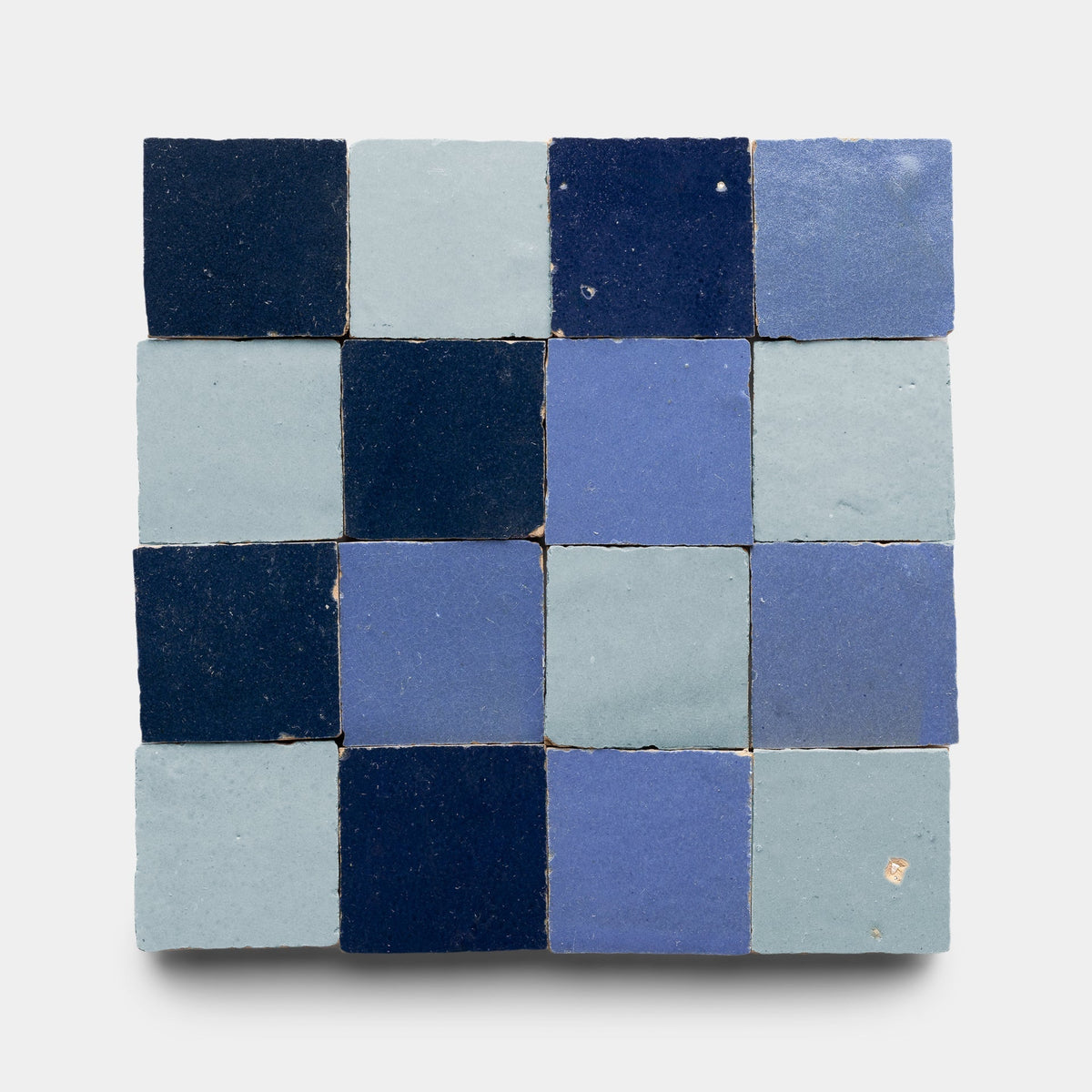 The Zia Tile Night Blue + Skylight + Portuguese Blue Checkerboard Sample features a 4x4 grid of 16 handmade tiles in alternating blue and navy shades on a light gray background.