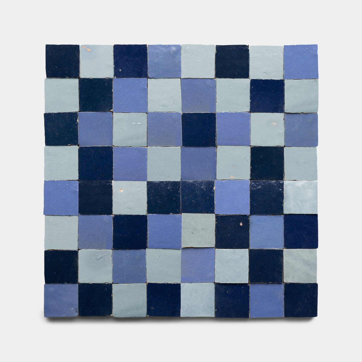 Zia Tile’s Night Blue + Skylight + Portuguese Blue Checkerboard sample showcases alternating blue shades in a checkerboard pattern, highlighting the brand’s signature handmade craftsmanship.