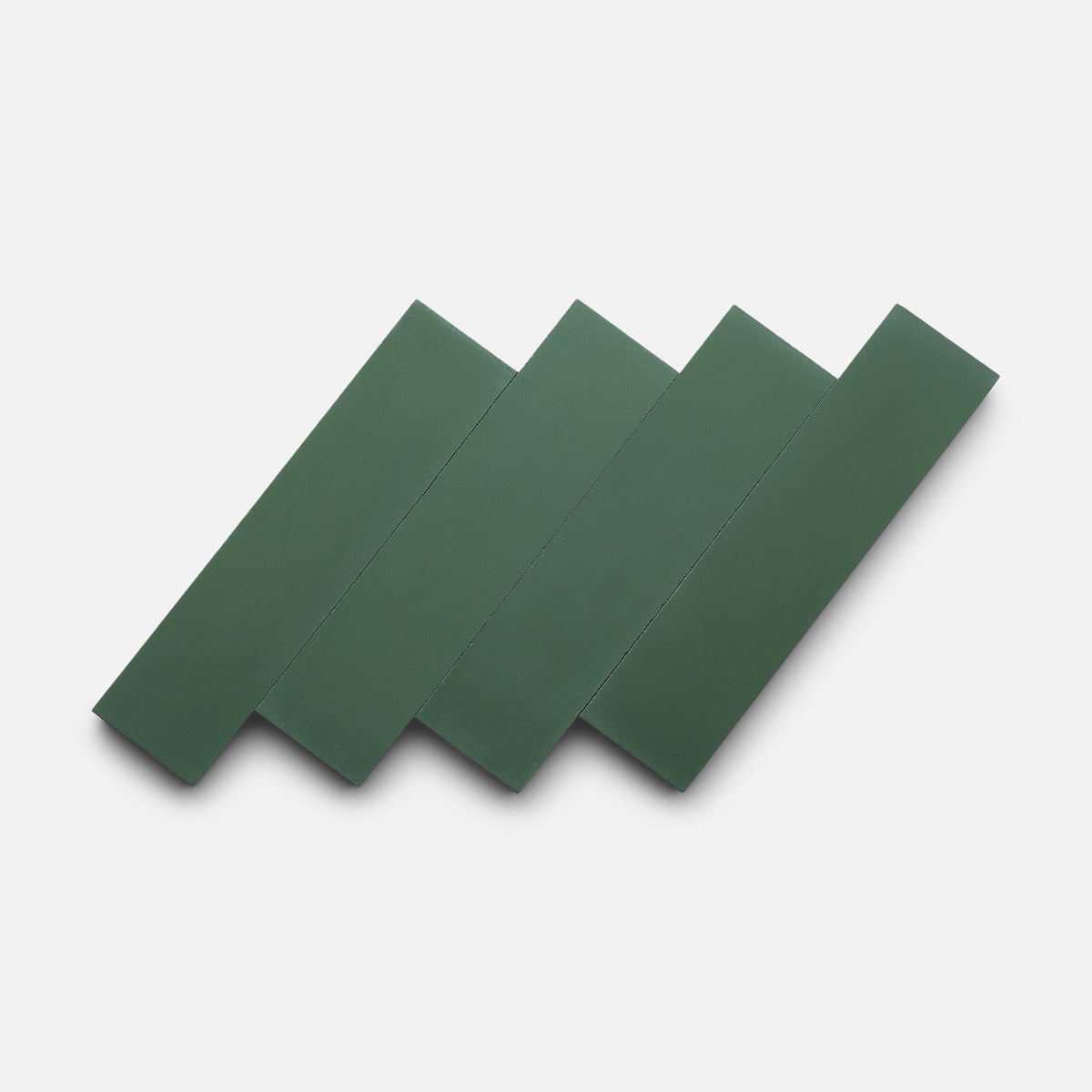 Four Noble Green 2x8 tile samples by Zia Tile are arranged diagonally and overlapping on a plain white background.