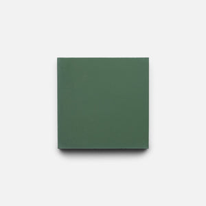 A Noble Green 4x4 sample tile by Zia Tile, featuring a solid green color, is centered on a plain white background.