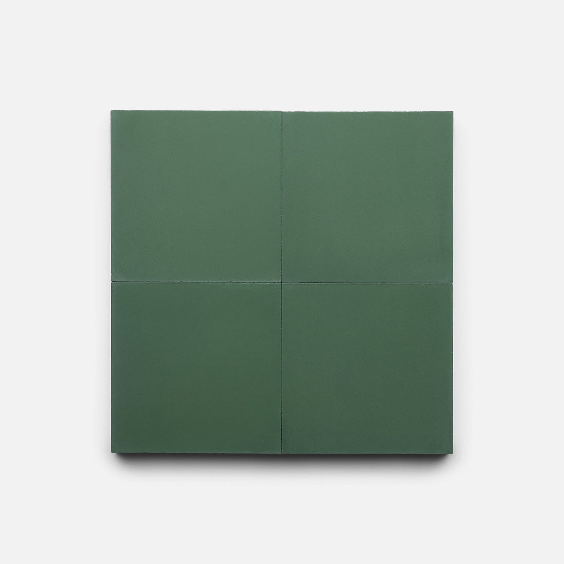 A square set of four matte, dark green Noble Green 4x4 sample tiles by Zia Tile, featuring clean edges and displayed on a plain white background.