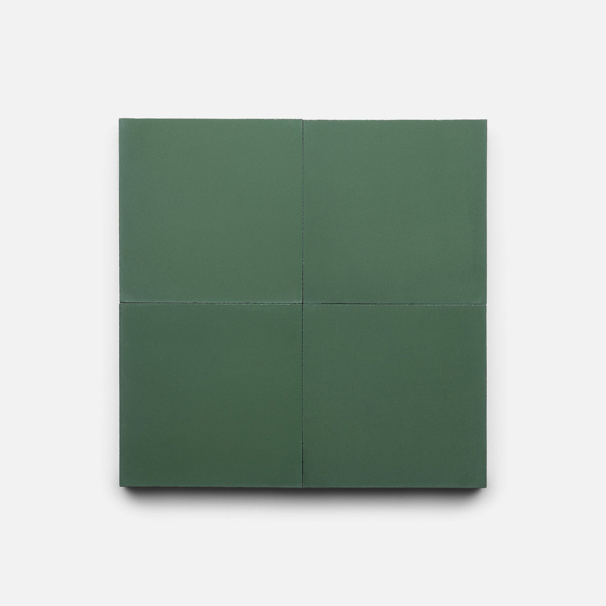 A square set of four matte, dark green Noble Green 4x4 sample tiles by Zia Tile, featuring clean edges and displayed on a plain white background.