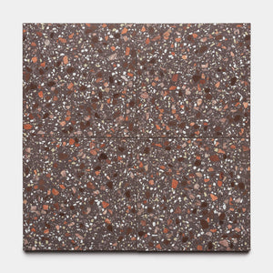 Four Nocino 12x12 tiles by Zia Tile are arranged in a square. Each brown terrazzo tile features red, white, and tan stone chips throughout the surface, displayed on a plain light background.