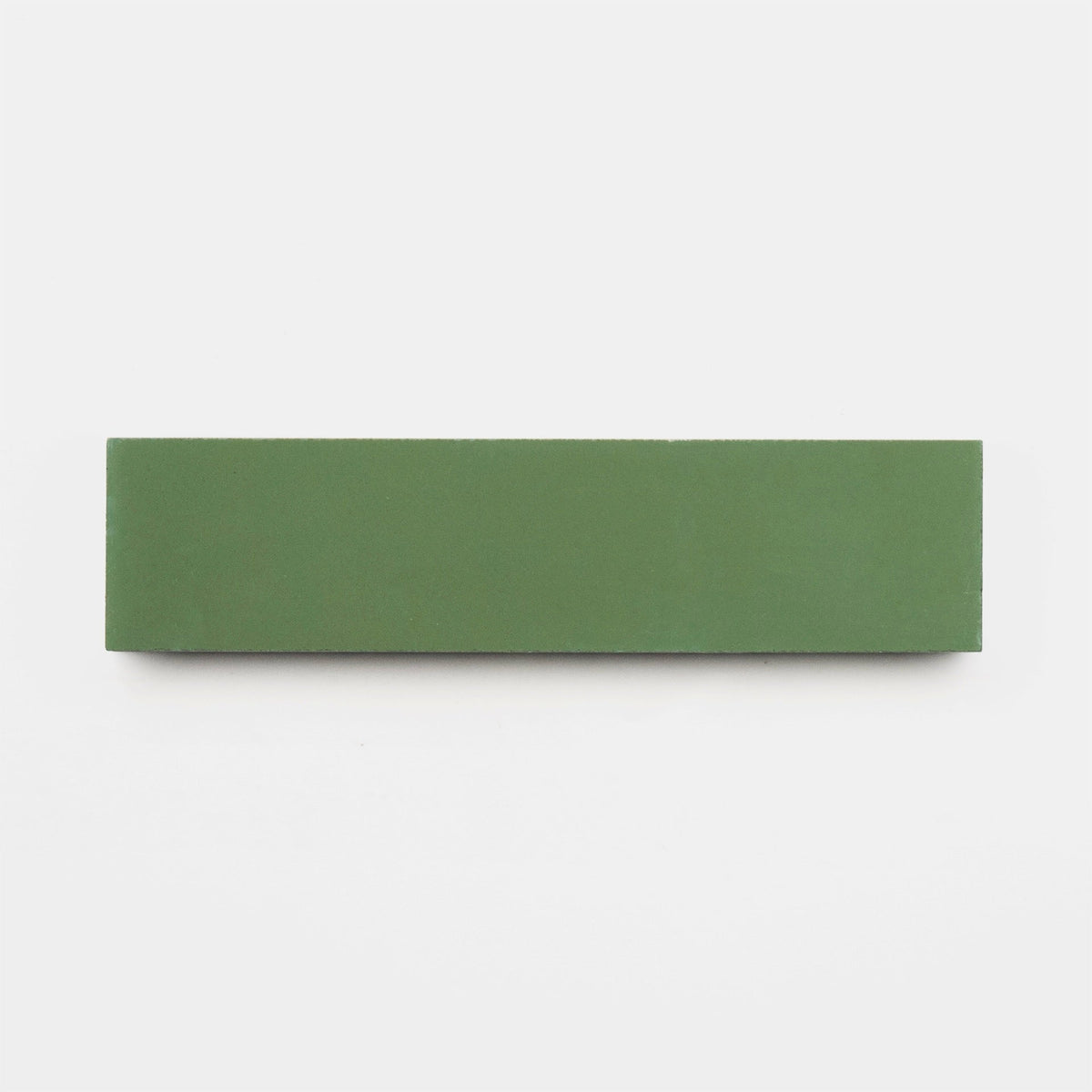 A rectangular Olivine 2x8 tile sample from vendor-unknown, green in color, is set on a plain white background—its smooth surface reminiscent of handmade tile.