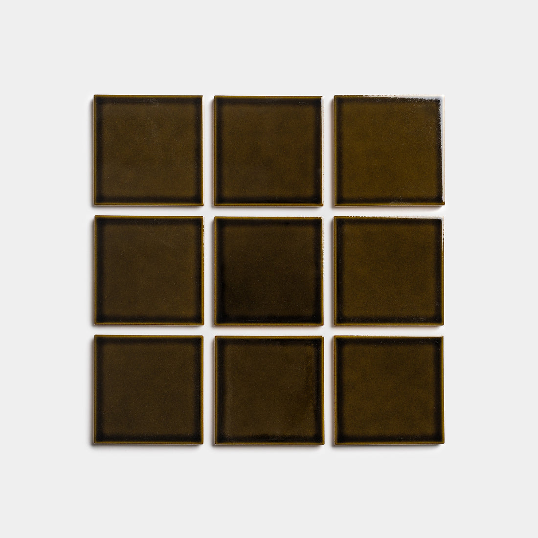 Nine Oud 4x4 square tiles by Zia Tile, in dark olive green, are arranged in a three-by-three grid on a plain light gray background.