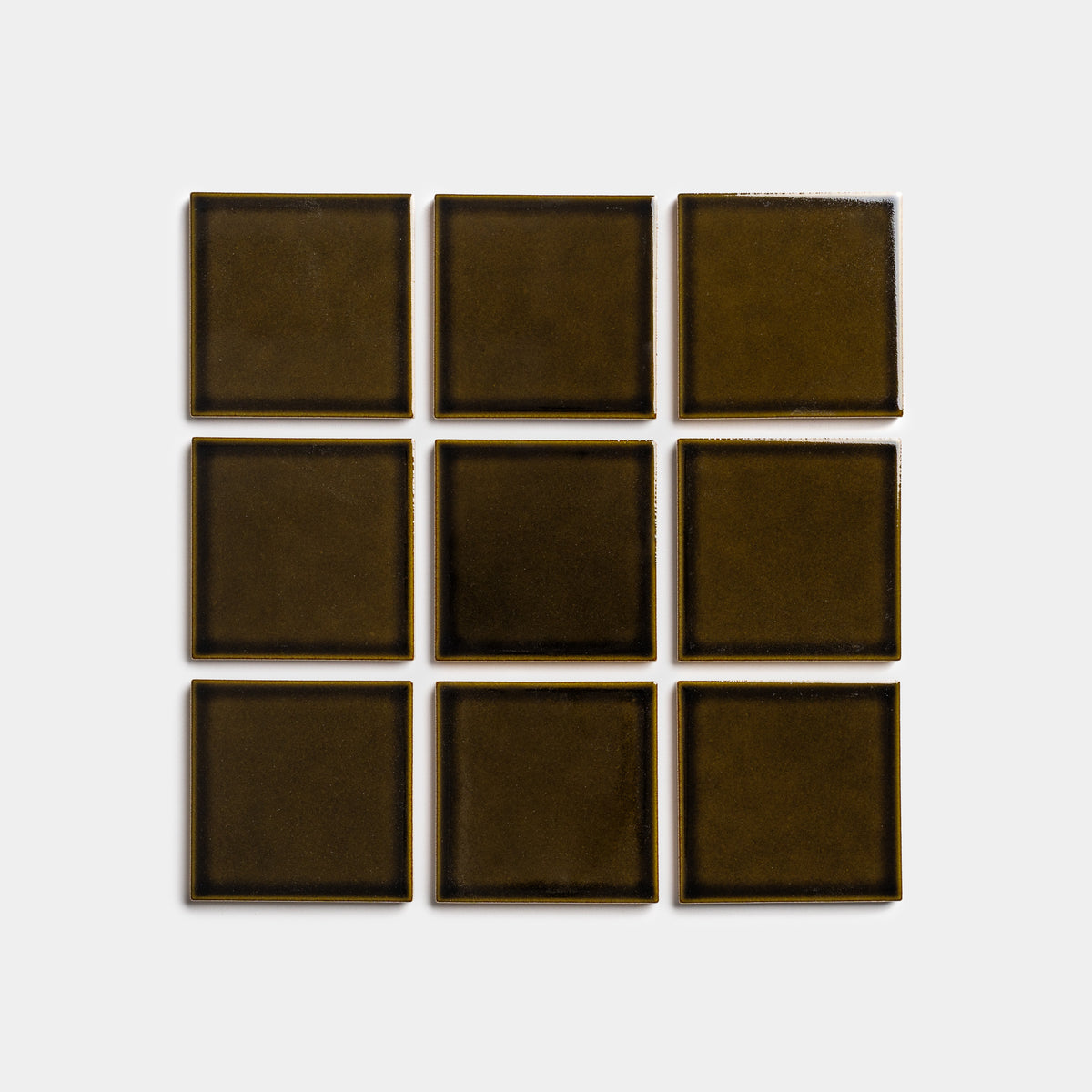 Nine Oud 4x4 square tiles by Zia Tile, in dark olive green, are arranged in a three-by-three grid on a plain light gray background.