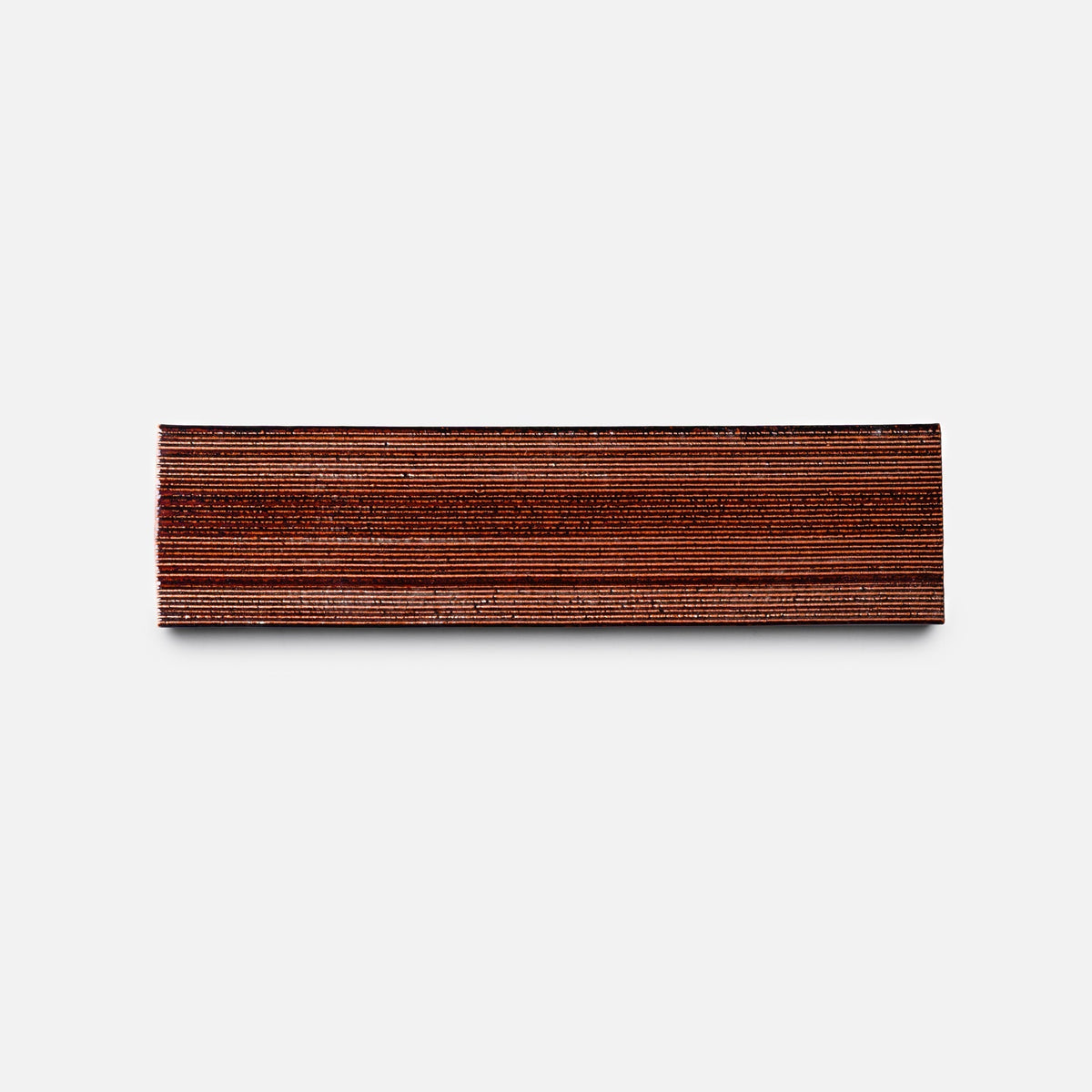 A neatly stacked rectangular pile of Oxblood + Etched, Sample wooden veneers by Zia Tile is placed against a plain white background.