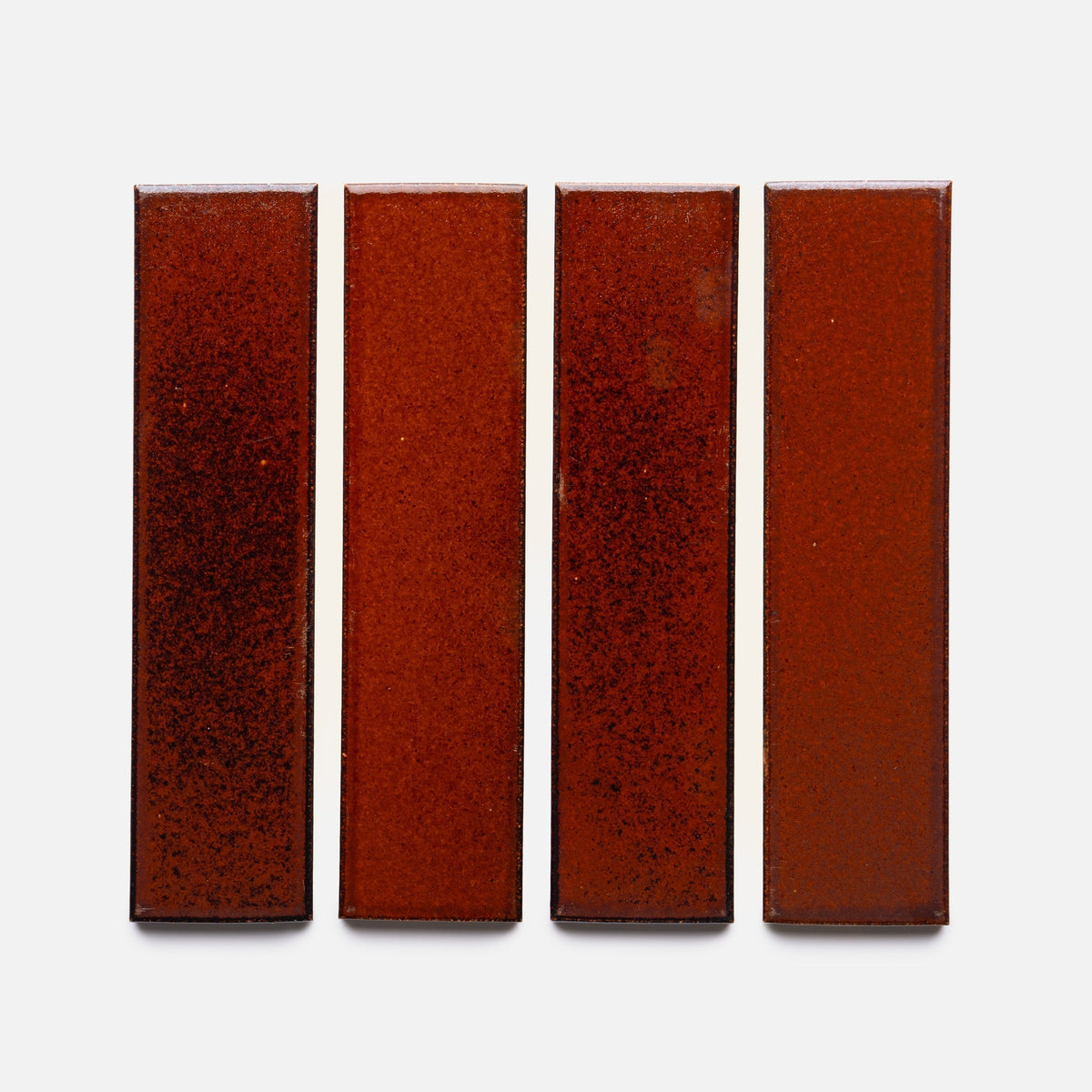 A row of Oxblood + Flat rectangular tiles by Zia Tile.