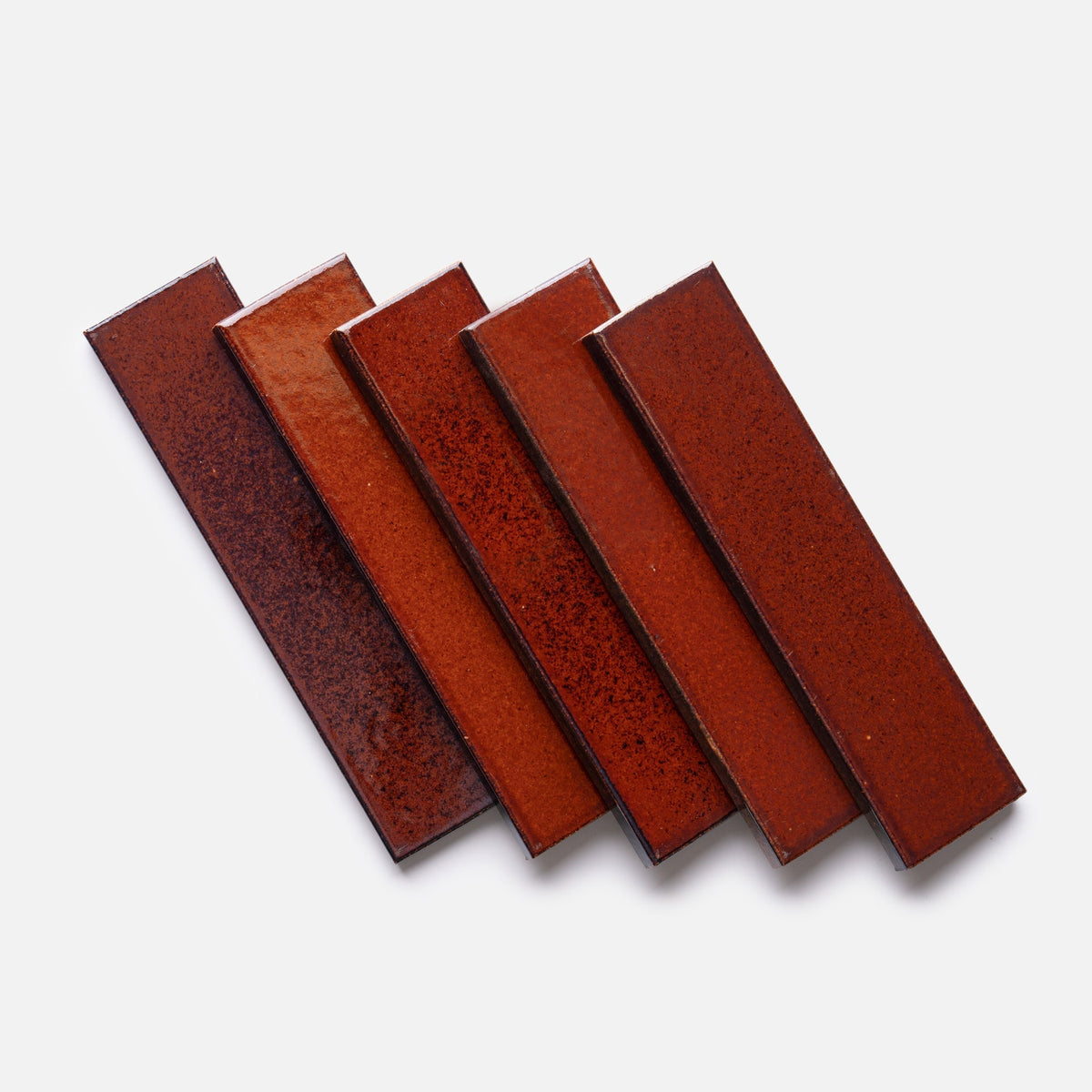 Five rectangular, glossy Oxblood + Flat ceramic tile samples by Zia Tile are fanned out on a plain white background.