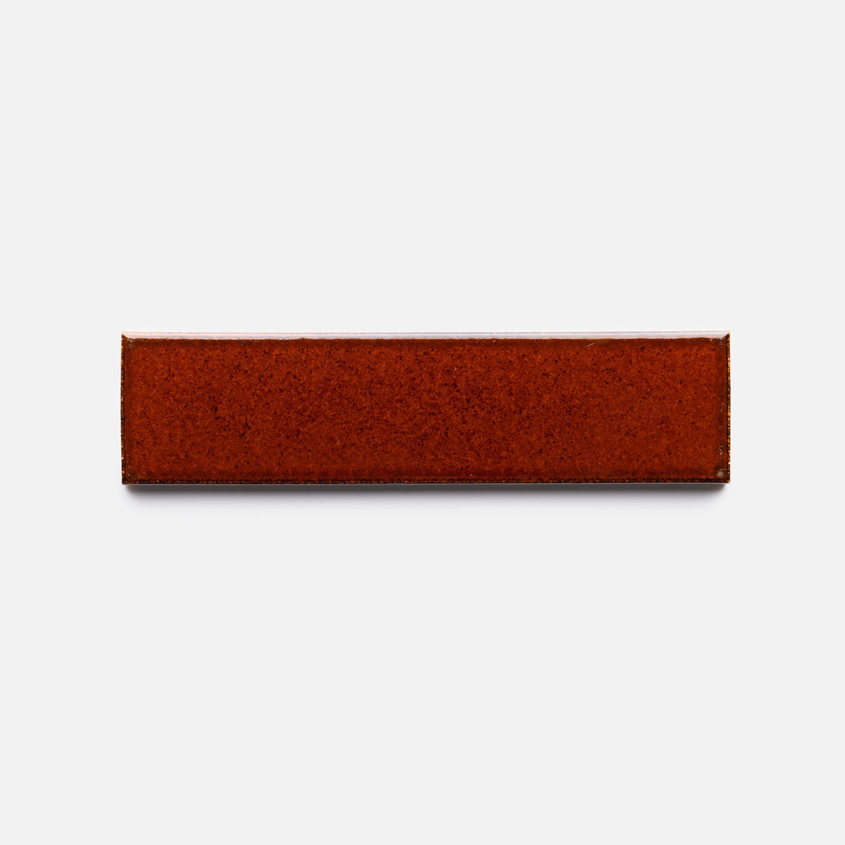 A rectangular Oxblood + Flat tile sample by Zia Tile in a reddish-brown hue is shown against a plain white background.