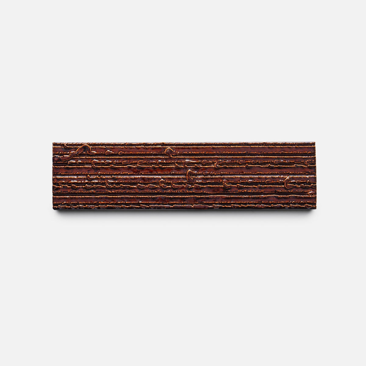 The Oxblood + Furrowed, Sample by Zia Tile is a rectangular tile with textured horizontal ridges and grooves, displayed on a plain white background.
