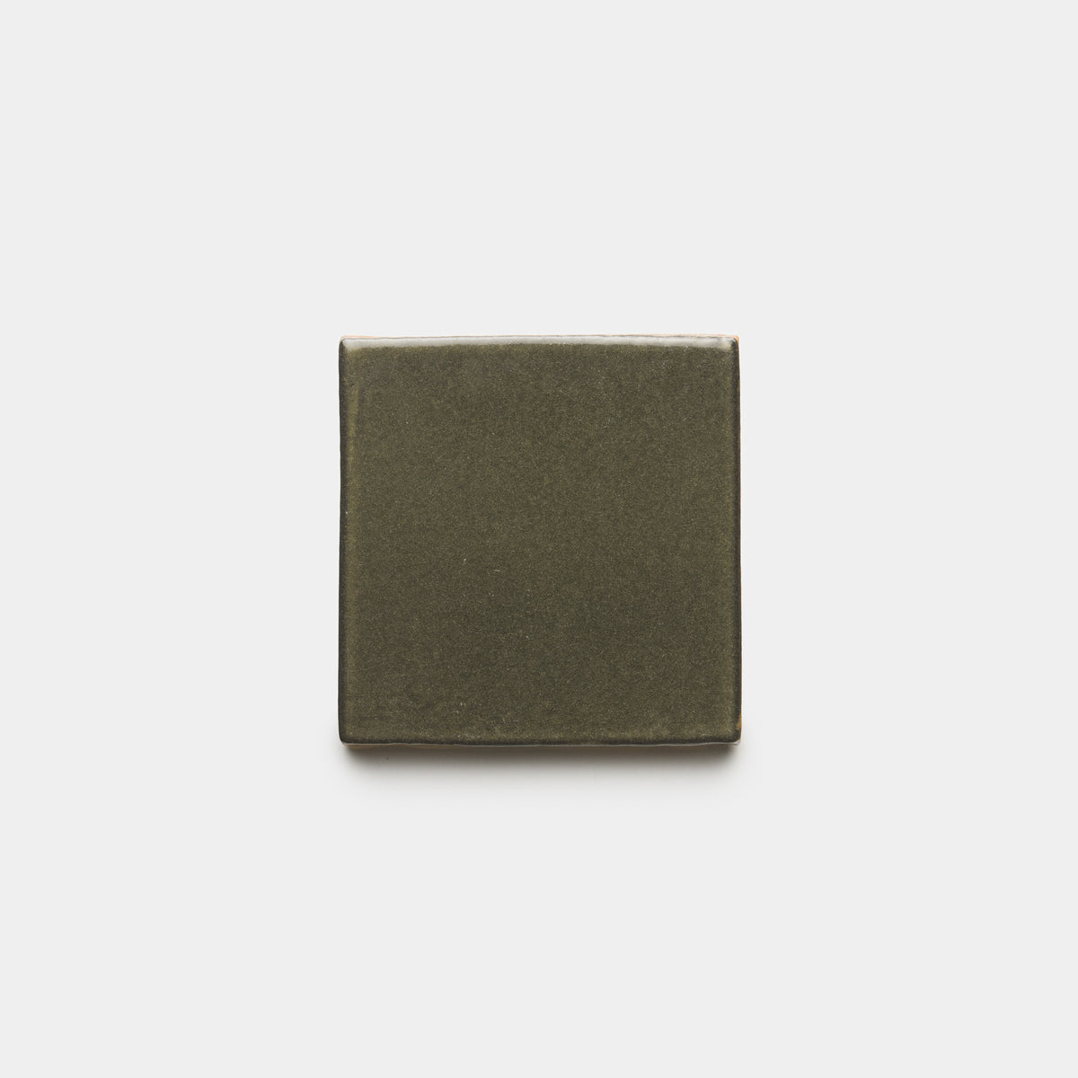 A single Oyamel 4x4 Square tile by Zia Tile in dark green ceramic is centered against a plain white background.